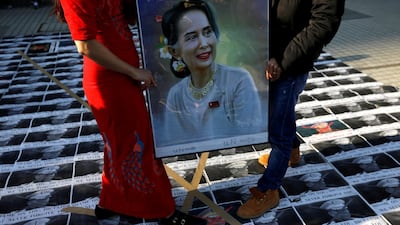 Myanmar protesters residing in Japan stand on pictures of Myanmar's army chief Min Aung Hlaing as they rally against the country's military after it seized power from a democratically elected civilian government. Reuters