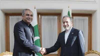 Iranian Foreign Minister Abbas Araghchi, right, shakes hands with Pakistan's Interior Minister Mohsin Naqvi in Tehran. Iranian Foreign Ministry / AFP