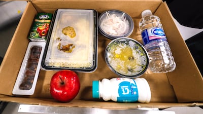 Each iftar box contains dates, laban, an apple, salad, juice and water.