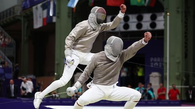 Egypt's Adham Moataz, left, competes against France's Maxime Pianfetti in the men's sabre team round of 8 bout between France and Egypt during the Paris 2024 Olympic Games at the Grand Palais in Paris. AFP