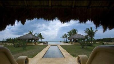 The cabanas and villas at Bar Reef Resort are made from natural materials, creating an almost seamless transition to the saltwater pool and ocean views. Kevin Clogstoun / Lonely Planet