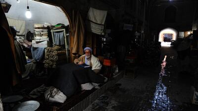 An Afghan vendor waits for customers at a stall in Herat on February 10, 2014. Afghanistan’s economy is recovering from decades of conflict, but despite significant improvement in the last decade, it is extremely poor and highly dependent on foreign aid. Aref Karimi / AFP photo