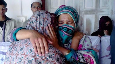 Family members of Maria Bibi comfort each other in Upper Dewal, Pakistan. Police said all five suspects in the killing were in custody. Muhammad Yousaf / AP Photo