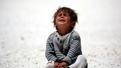 A displaced Syrian child cries at refugee camp in the northern Syrian village of Ain Issa. Delil Souleiman / AFP Photo