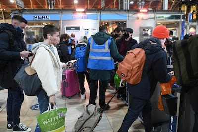 Masses of people go through barriers to catch trains at Paddington Station in London after the announcement that London will move into tier four Covid restrictions from midnight. Stefan Rousseau / PA Images