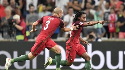 Renato Sanches, right, celebrates after scoring the equalising goal. Martin Meissner / AP Photo