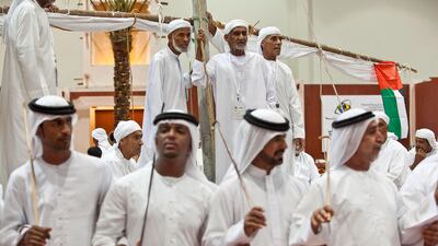 Exhibitors and members of Abu Dhabi cultural foundation watch a traditional dancing show. Antonie Robertson / The National