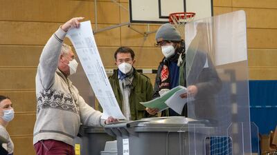 An election worker holds up a ballot paper at local elections in March, with all of Germany heading to the polls in September. AP