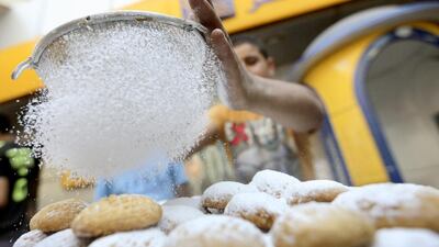 A baker makes traditional sweets in Cairo. Egypt imported 726,000 tonnes of sugar in the first 10 months of 2014, 90 per cent of it from Brazil. Mohamed Abd El Ghany / Reuters