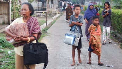 Indonesians leave their homes in Talibura, East Nusa Tenggara province, after the powerful quake. Reuters