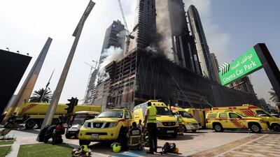 Members of Dubai Civil Defence were quickly at the scene of the fire to rescue four workers trapped in the under-construction Fountain Views residential building Dubai Mall and the Burj Khalifa, the world’s tallest building. Karim Sahib / AFP