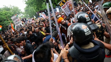 Supporters of India's Cockroach Janta Party scuffle with police outside the parliament building in New Delhi. Reuters