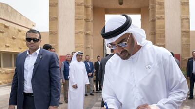 Sheikh Mohamed signs the guests book during a tour at Al Alamein Military Museum. Mohamed Al Hammadi / Ministry of Presidential Affairs