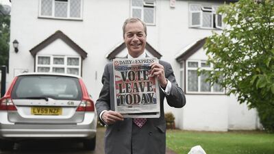 Mr Farage, leader of UKIP and Vote Leave campaigner, holds up the Daily Express as he returns home after buying newspapers in Westerham in 2016