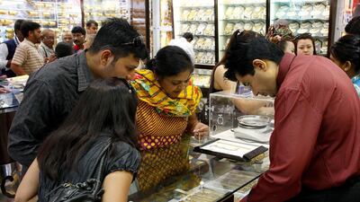 Customers barter over the price of gold products at the Gold Souq in Deira, Dubai. Jake Badger for The National