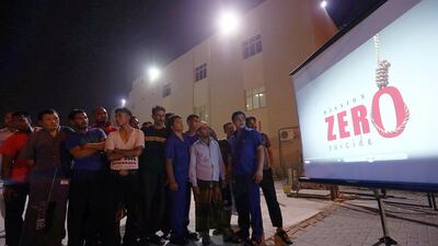 People watch a video on the World Suicide Prevention Day with messages and videos organised by UAE exchange Satish Kumar / The National