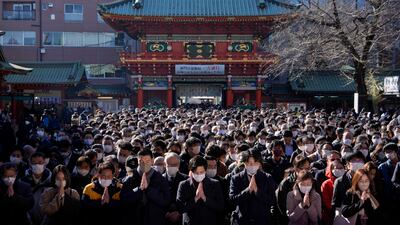 Business people offer prayers for prosperity for their companies and the economy at the Kanda Myojin Shrine in Tokyo. EPA
