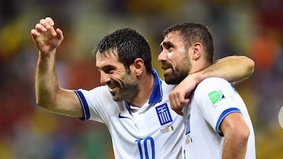 Giorgos Karagounis, left, and Giannis Maniatis of Greece celebrate after defeating the Ivory Coast 2-1 during their 2014 Fifa World Cup Group C match at Castelao on June 24, 2014 in Fortaleza, Brazil. Laurence Griffiths / Getty Images