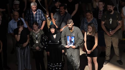 Friends and relatives mourn the death of fighter pilot Andrii Pilshchykov, 30, who was killed along with two other pilots in a mid-air plane crash in Kyiv, in August 2023. Getty Images