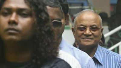 The Maldivian President Mamoun Abdul Gayoom, right, stands in a queue to cast his vote at a polling station in Male.