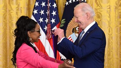 Mr Biden awards singer Gladys Knight with the 2021 National Medal of Arts. AFP