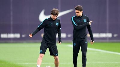Sergio Roberto (L) of FC Barcelona talks with his teammate Marc Bartra of FC Barcelona during a training session ahead of their Uefa Champions Leage round of 16 second leg match against Arsenal FC at Ciutat Esportiva on March 15, 2016 in Barcelona, Spain. (Photo by David Ramos/Getty Images)