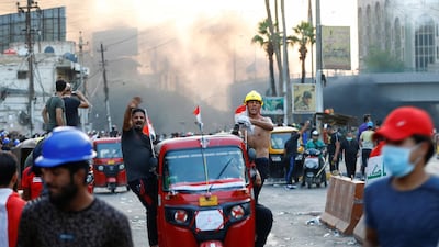 Demonstrators use a tuk-tuk as they carry a wounded man in Baghdad. Reuters