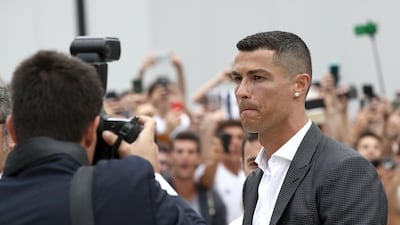 Ronaldo walks out the Juventus medical center to greet supporters. AFP