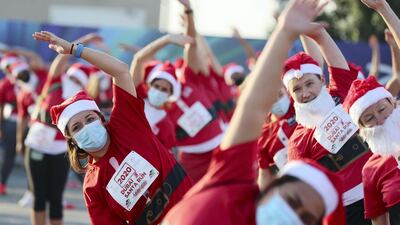 The team of Santas stretch their limbs ahead of the race