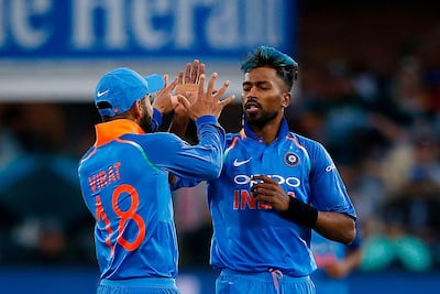 Hardik Pandya, right, needs to emulate Virat Kohli in substance. Marco Longari / AFP