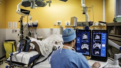 A doctor performs a robot-assisted prostate tumorectomy in France. Jeff Pachoud / AFP