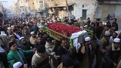 People carry the coffin of a male student who was killed in Tuesday's attack on the Army Public School in Peshawar. Fayaz Aziz / Reuters