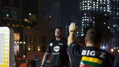 An official lifts his hand to signal that a contestant can lift the weights at the World's Ultimate Deadlift, Burj Plaza, Dubai.