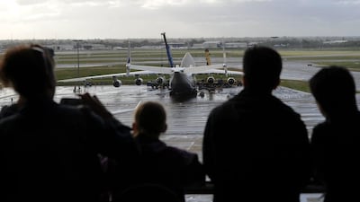 Spectators look out from an indoor viewing room at Perth Airport. Greg Wood / AFP