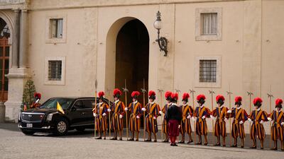 Members of the Vatican's Swiss Guard look on as Joe Biden's motorcade arrives. AP Photo
