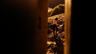 Alondra Rios Caseras, 7, walks up a hill to meet waiting US border patrol agents after she, her parents, and her two sisters crossed over the border fence. AP Photo