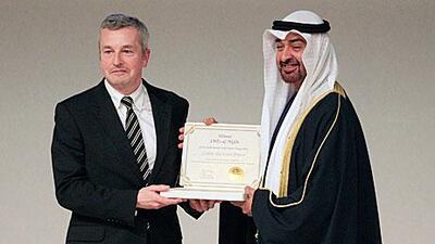 Sheikh Mohammed bin Zayed, Crown Prince of Abu Dhabi and Deputy Supreme Commander of the UAE Armed Forces, presents the Zayed Future Energy Award to Paul Dickinson, the executive chairman of the Carbon Disclosure Project for its pioneering use of market-based tools to solve environmental issues.