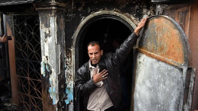 An Egyptian police investigator stands the entrance of a Cairo disco where a petrol bomb attack took place. Moahmmed El-Shahed / AFP Photo