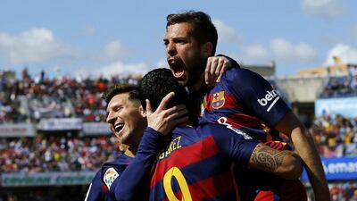 Luis Suarez, centre, celebrates scoring Barcelona's opening goal with teammates Lionel Messi, left, and Jordi Alba. Marcelo del Pozo / Reuters