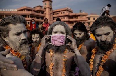 A Naga Sadhu, or Hindu holy man, wears a mask before the procession for taking a dip in the Ganges River during Shahi Snan at Kumbh Mela, or the Pitcher Festival.