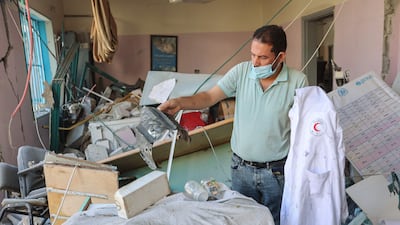 Palestinians inspect the damage at a clinic in Gaza city after it was hit by an Israeli strike. AFP