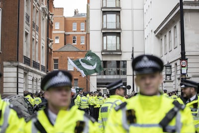 Police officers watch as a protest is staged in front of the house of Nawaz Sharif in London. Getty Images