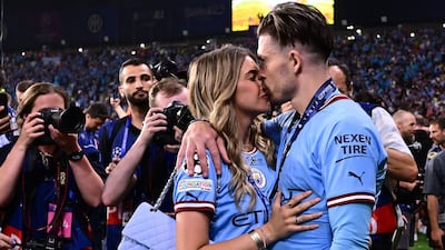 Jack Grealish celebrates with his girlfriend Sasha Attwood. AFP
