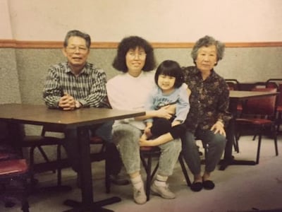 Evelyn Lau as a young girl with her mother and grandparents at her family's Chinese restaurant in Massachusetts in the early 1990s. Photo: Evelyn Lau