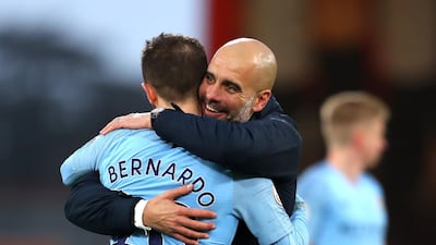 Manchester City manager Josep Guardiola embraces Bernardo Silva following the Premier League match between AFC Bournemouth and Manchester City at Vitality Stadium in Bournemouth. Getty Images