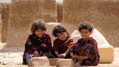 Afghan children pose for a photograph near their temporary shelter in Mazar-e-Sharif, Afghanistan. Sayed Mustafa / EPA