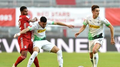 Bayern Munich's Serge Gnabry in action with Borussia Monchengladbach's Florian Neuhaus and Ramy Bensebaini. Reutes