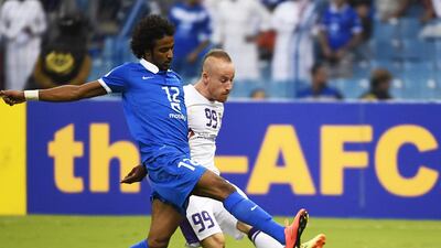 Yasir Al Shahrani, left, of Al Hilal blocks a shot by Al Ain's Miroslav Stoch during their Asian Champions League semi-final first leg match on September 16, 2014, at the King Fahd International stadium in Riyadh. Fayez Nureldine / AFP