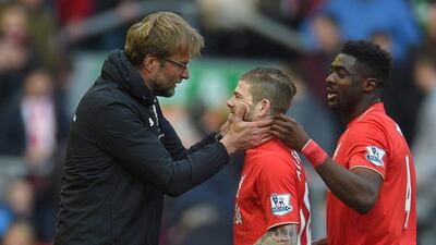 Liverpool's manager Juergen Klopp (L) reacts with Alberto Moreno (C) and Kolo Toure (R) during the English Premier League soccer match between Liverpool and Stoke City at the Anfield, Manchester, Britain, 10 April 2016. EPA/PETER POWELL