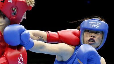 Karolina Michalczuk, left, of Poland defends against Chungneijang Mary Kom Hmangte of India during the women's flyweight boxing round of 16 on August 5, 2012, at the 2012 London Olympic Games. Jack Guez / AFP